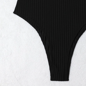Detail shot of black ribbed texture fabric on one-piece swimsuit with smooth stitching