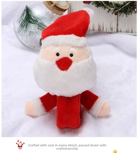 Detail of plush Santa Claus snap bracelet on a snowy festive background with ornaments