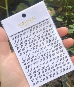 Detail shot of WG720 3D nail stickers featuring black gothic alphabet letters