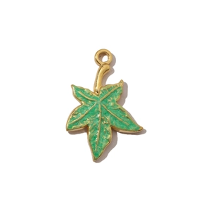 Macro detail of leaf-shaped green enamel pendant with gold-plated stainless steel edges