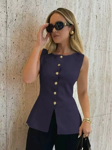 Detail of navy blue sleeveless knit vest with elegant gold buttons and side slit hemline