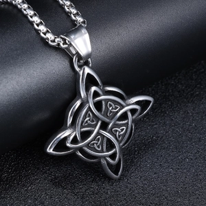 Detailed view of silver Celtic knot pendant with vintage viking style on black background