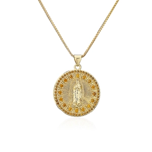Detail of 18K gold plated necklace with zircon relief pendant and amber stone inlay