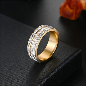 Detailed view of the triple-row micro-paved zircon stones on a gold titanium steel ring.