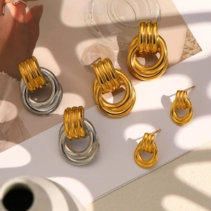 Macro shot of two-tone layered circle earrings in gold and silver stainless steel