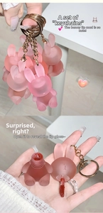 Detail view of rabbit-shaped matte lip clay with keychain hook and applicator brush head