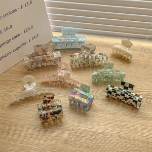Elegant multi-color acetate hair claws in various marble and tortoiseshell patterns