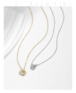 Detail of s925 silver interlocking circle necklaces in gold and silver with sparkling stones