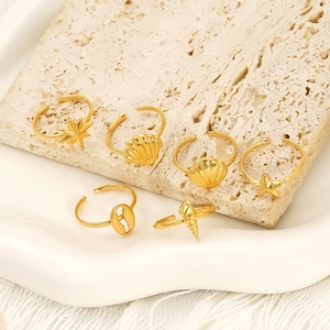 6-piece gold ocean ring set featuring starfish and seashell designs on stone