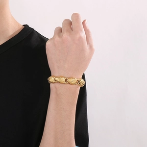 Macro detail of men's 18k gold plated stainless steel bracelet with leopard head design