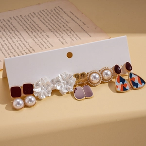 Five-pair set of resin pearl flower and geometric earrings on a display card