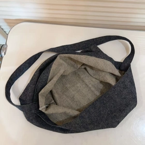 Detail view of large denim tote bag interior showing spacious tan lining and fabric texture
