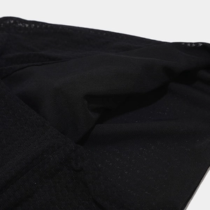 Close-up of black breathable knit fabric texture for fitness beanie showing mesh detail
