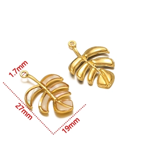 Detailed size view of tropical leaf charms in gold metal and iridescent mother of pearl