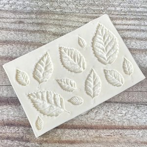 Detailed macro view of food-grade silicone leaf molds featuring 11 distinct vein textures