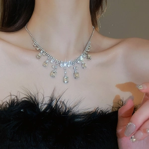 Close-up of sparkling square rhinestone fringe necklace on a model for a vintage look