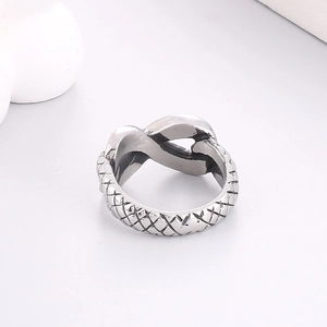 Detail shot of the silver woven texture and knot design on the titanium steel ring