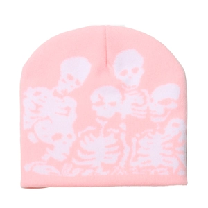 Detailed close-up showing the white skull pattern on a pink knitted beanie texture