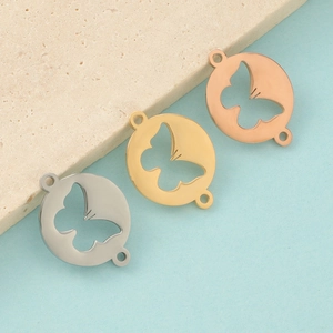 Three hollow butterfly pendants in silver, gold, and rose gold with polished metal finish