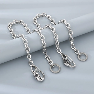 Silver punk skull dragon head pant chain with metallic luster on blue fabric background