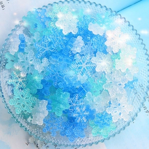 Close-up of translucent glitter resin snowflake charms for DIY jewelry and hair accessories