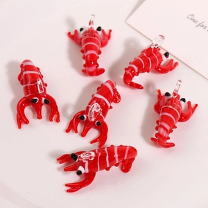 Close-up of 6-piece red glass lobster pendants with white stripes for DIY jewelry making