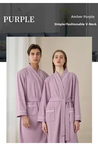 Detail of waffle weave texture on purple bathrobe with white contrast piping on v-neck collar