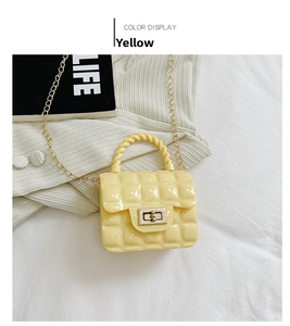 Detail of yellow quilted jelly bag with golden twist lock and chain strap