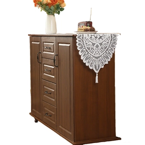 Retro brown wooden storage cabinet with drawers and white lace runner on top