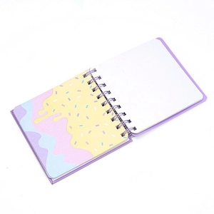 Mini spiral notebook with purple cartoon cover and colorful wave patterns on pages