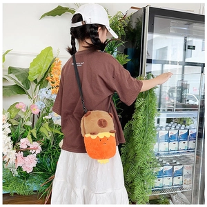 Rear view of child wearing a cute plush Capybara crossbody bag with adjustable strap