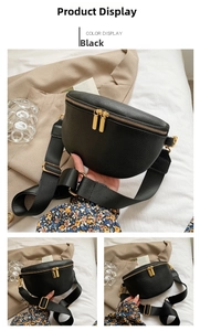 Detail of black lychee grain leather crossbody bag with golden double zipper closure