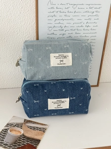 Denim makeup bag set with bow pattern and heart-shaped zipper in light and dark blue