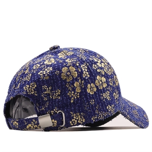 Navy denim baseball cap with vintage gold floral patterns and metal buckle detail