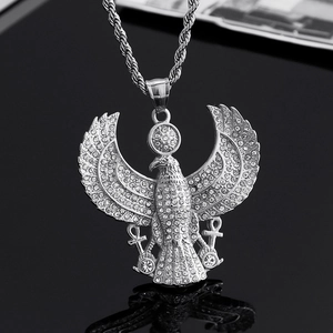 Macro shot of silver hip hop eagle pendant with rhinestones and double Ankh symbols