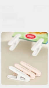 Detail of durable white and pink plastic clips for laundry and food sealing