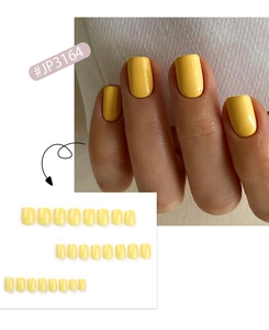 Short square press-on nails in bright yellow color showing full set and hand application