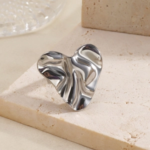Irregular silver heart ring with liquid fold texture on minimalist stone base