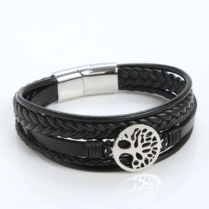 Detailed view of black braided leather bracelet with tree of life charm and silver magnet clasp