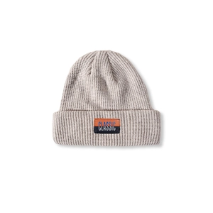 Close-up of a light grey knit beanie featuring a classic woven patch and thick texture
