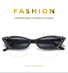 Close-up of cat-eye sunglasses with luxury rhinestones and dark grey lenses