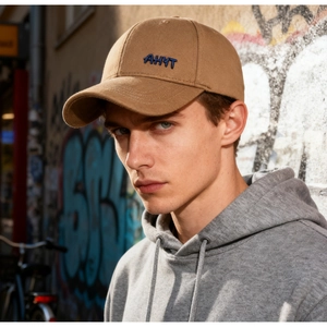 Detailed blue AHYT embroidery on khaki winter baseball cap worn by male model outdoors