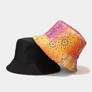 Reversible tie-dye bucket hat with colorful paisley pattern and solid black side