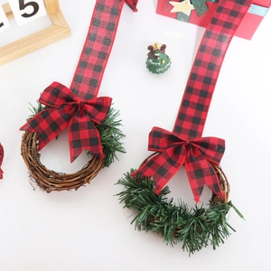 Detail of Christmas wreath with red and black buffalo plaid bow on rattan ring for cabinet