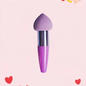 Detail view of a purple heart-shaped sponge makeup brush with a sleek metallic silver ferrule