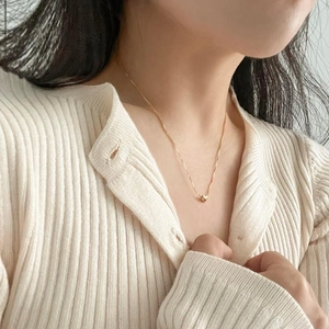 Elegant 925 sterling silver gold heart necklace worn by a model on collarbone