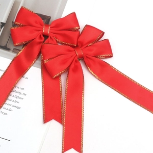 Velvet Christmas bow with gold edge trim displayed on a white decorative background