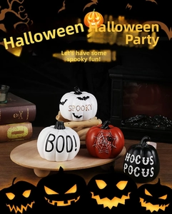 Detailed view of Halloween resin pumpkins with Spooky and Boo lettering on wood tray
