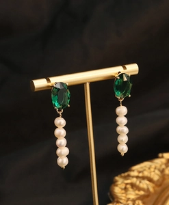 Detail of drop earrings with emerald-green stone and five natural freshwater pearls