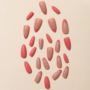 Set of almond press-on nails in nude pink and coral red with pearls and gold beads